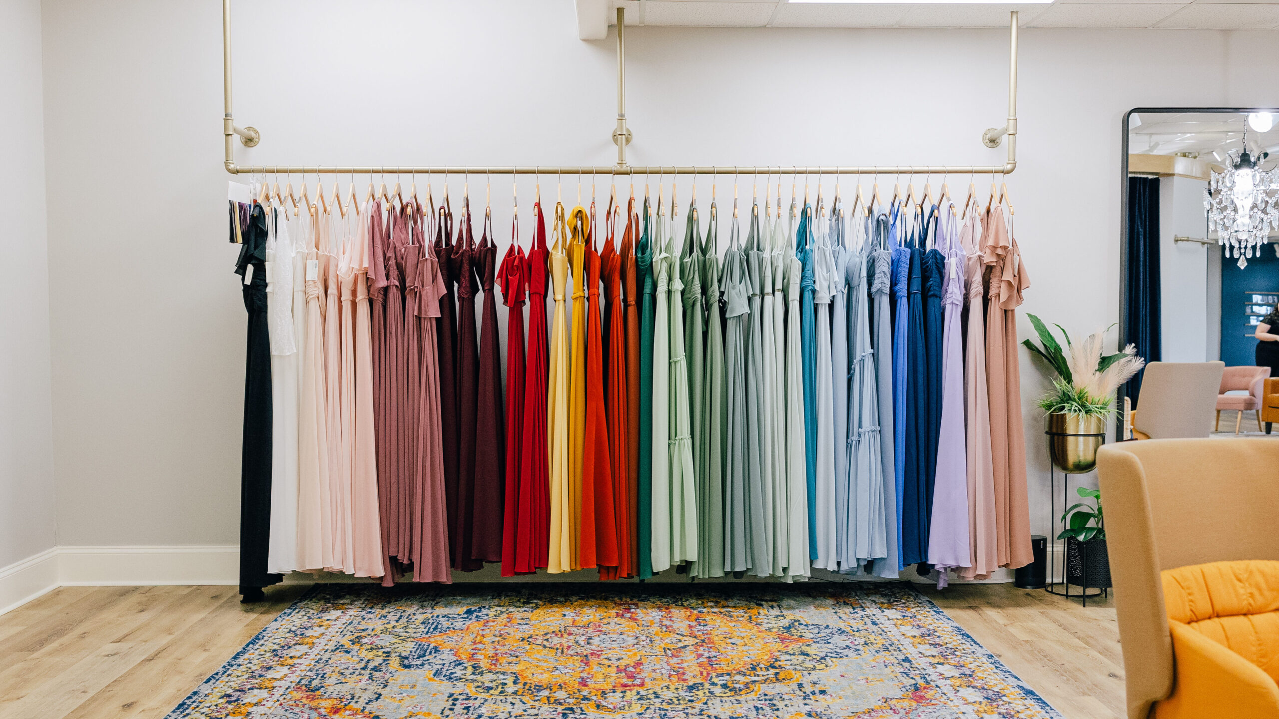 rack of colorful bridesmaid gowns