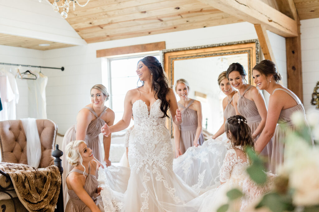 six bridesmaid and ring bearer helping bride get ready