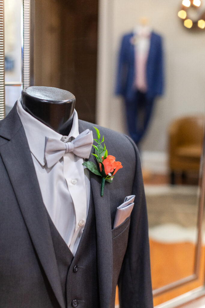 black tux with corsage on mannequin