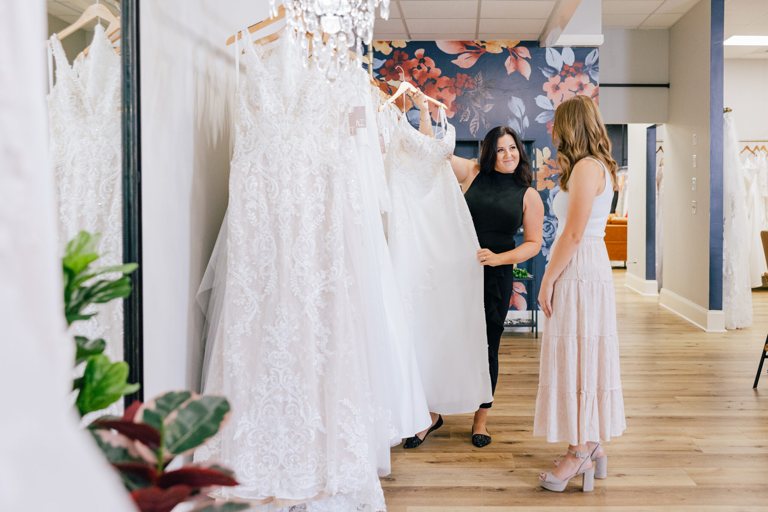 stylist displaying bridal dress to bride to be