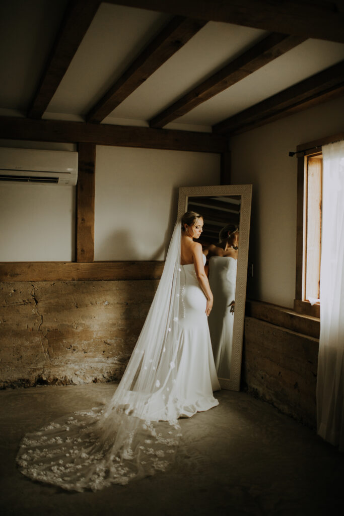 woman in bridal gown in low lit room