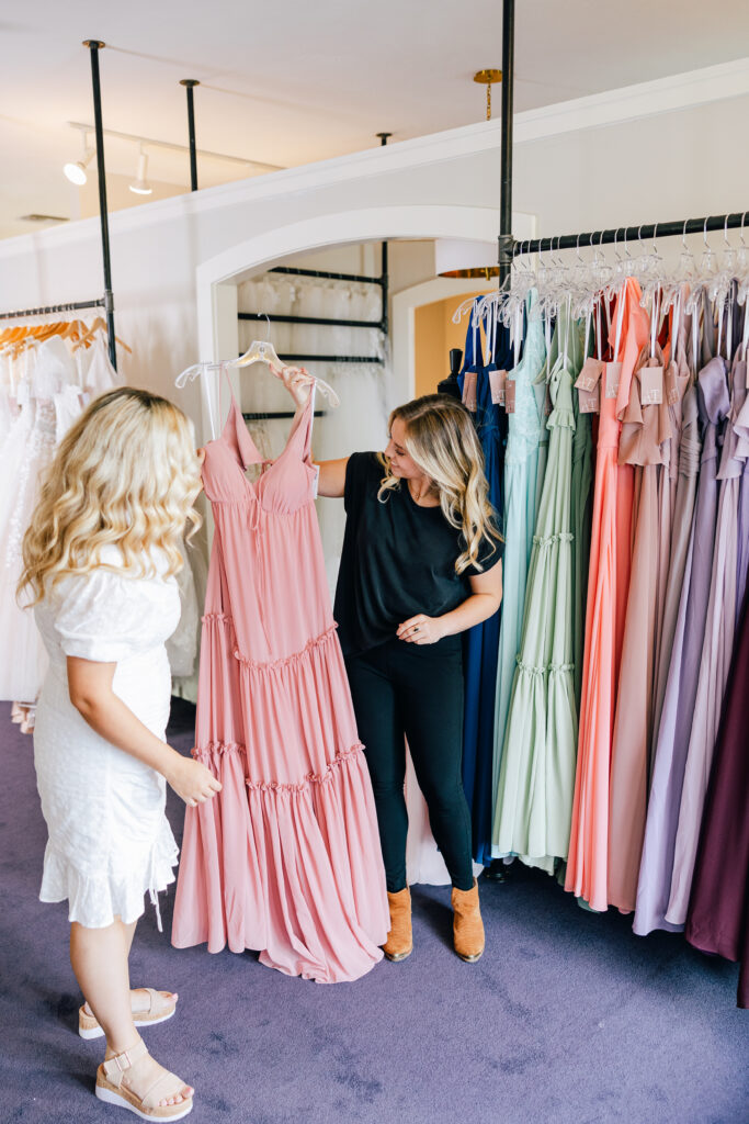 bridal stylist and customer shopping for wedding dresses