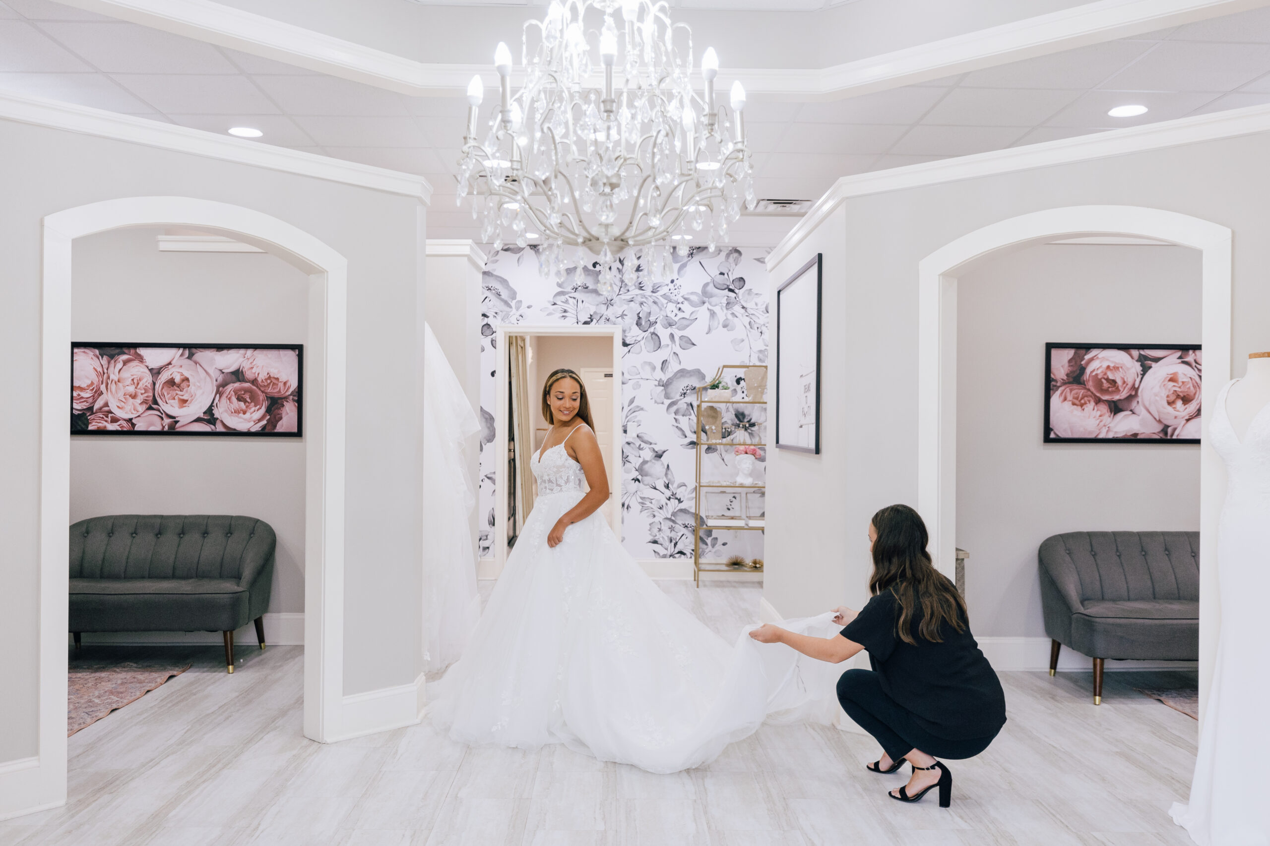 stylist holding up bridal gown train