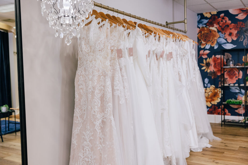 rack of white bridal dresses at amanda's touch