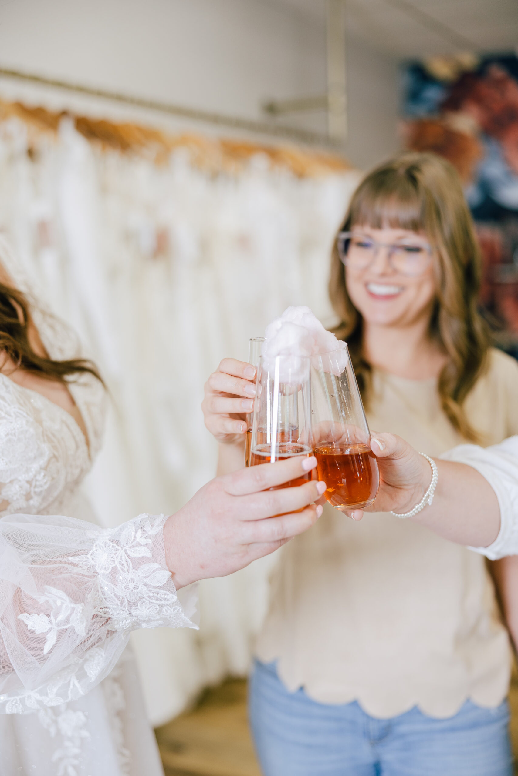 stylist and bride cheersing red drink