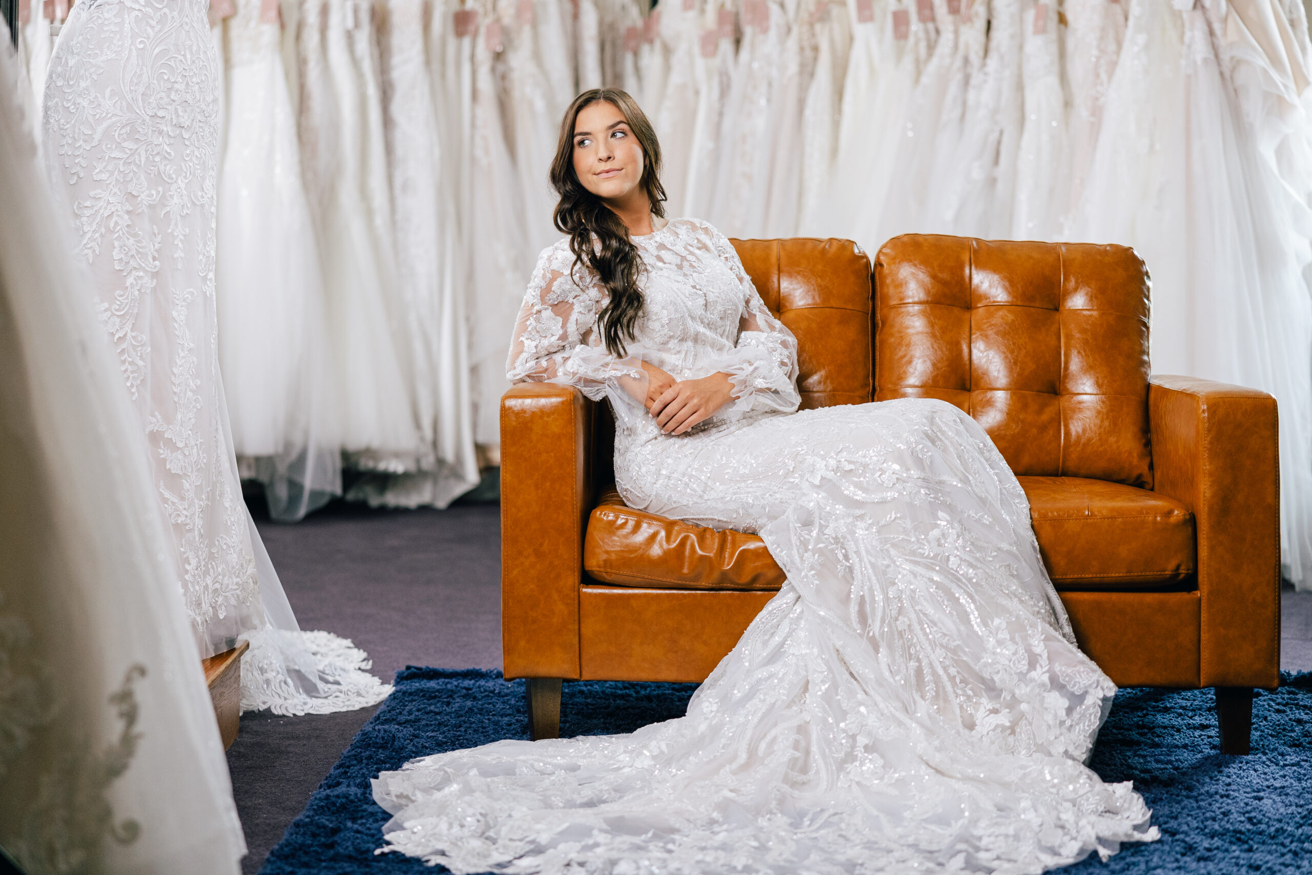 bride sitting on couch posing in a beautiful wedding dress