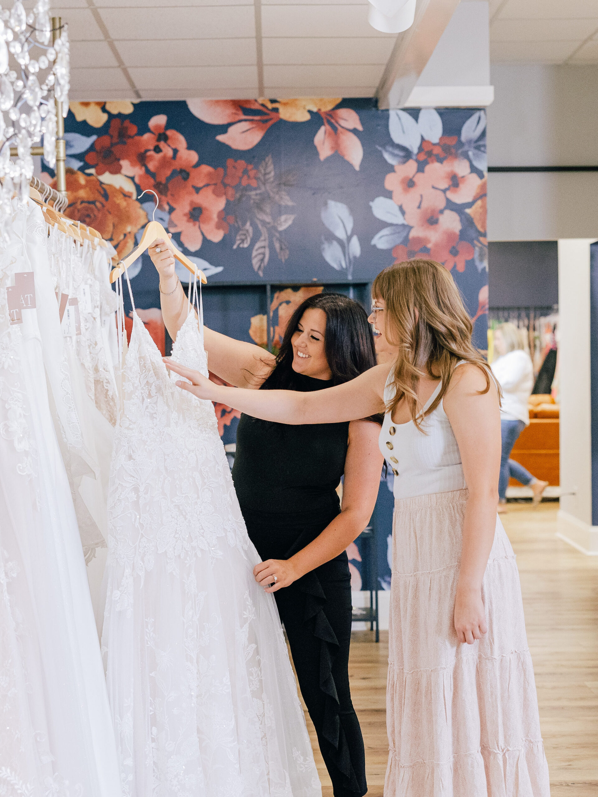stylist and bride to be shopping for bridal dresses