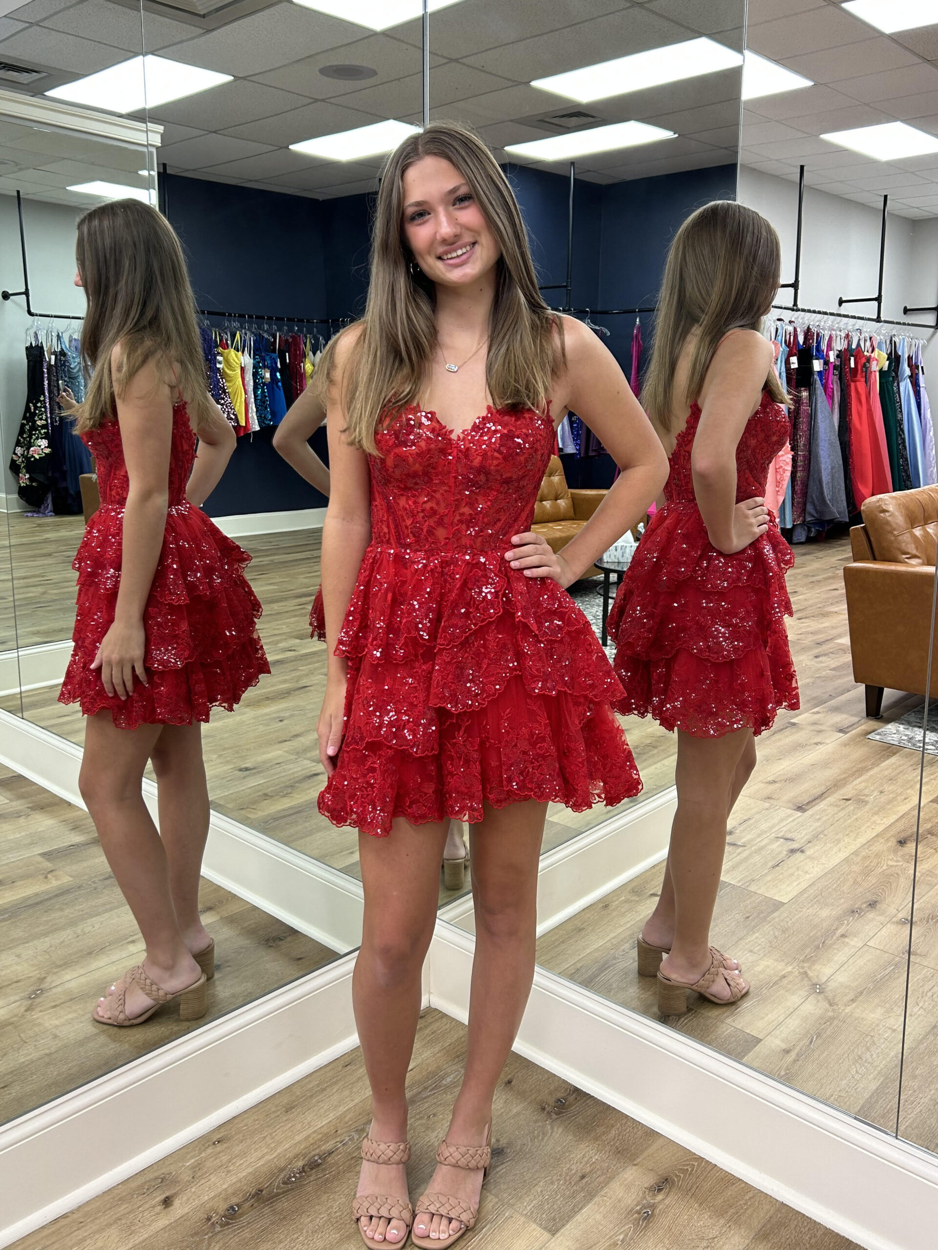 girl posing in red homecoming dress in front of mirrors
