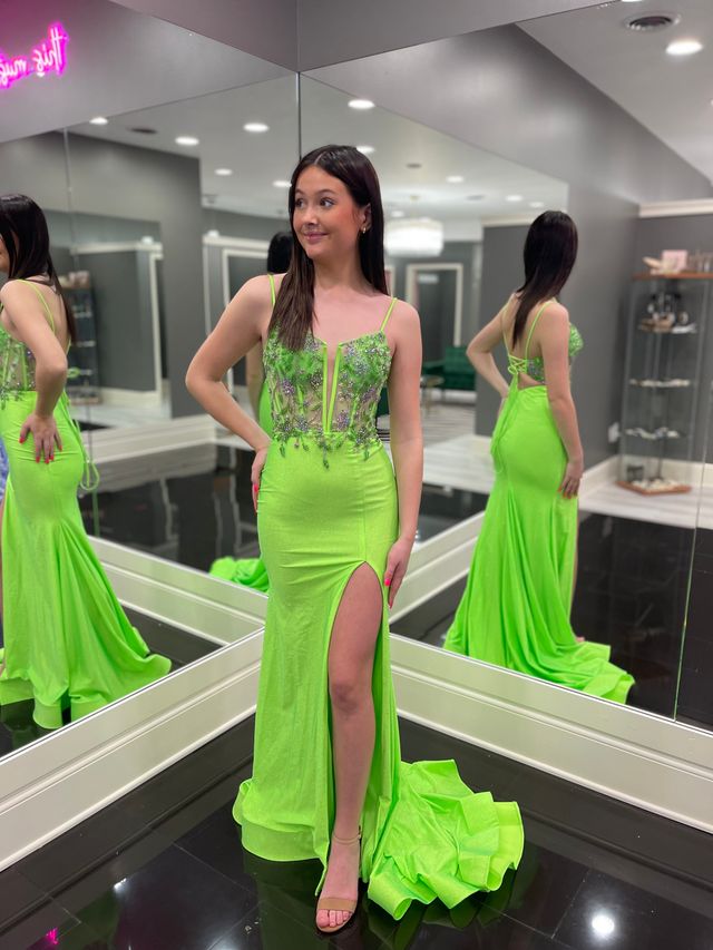 a high schooler wearing a lime green sheath prom dress at Amanda's Touch