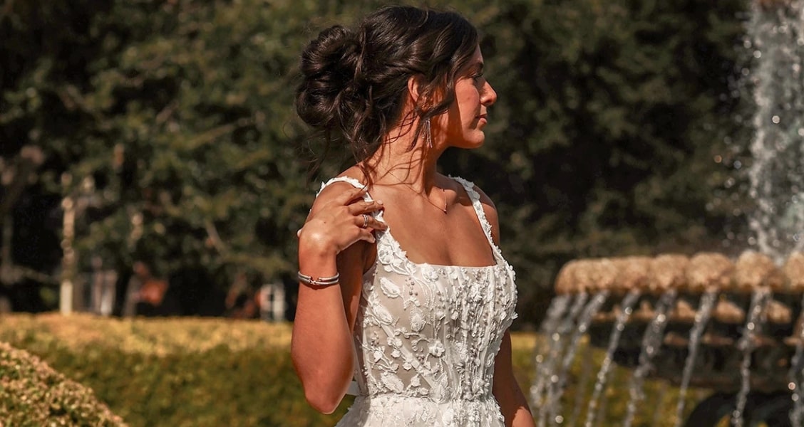 Bride wearing an intricately detailed floral wedding dress with 3D lace applique