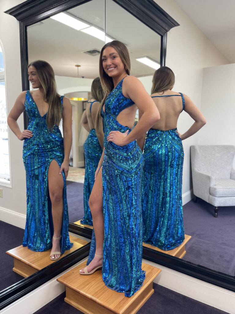 A high school student wearing a bright blue dress with sequin, getting ready for prom