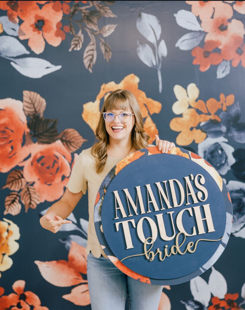 Amanda's Touch bride holding a sign that says "Amanda's Touch Bride."