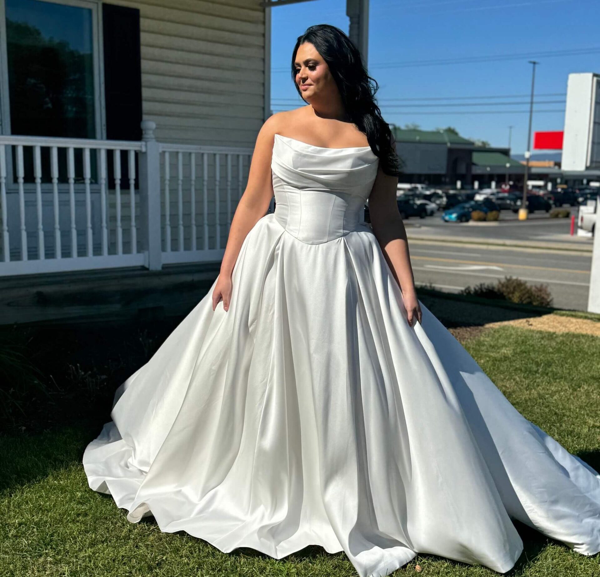 Bride standing outside in white corset inspired wedding dress